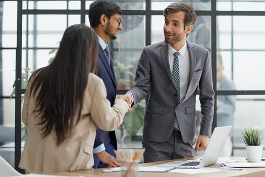 Euphoric excited business team celebrate corporate victory together in office