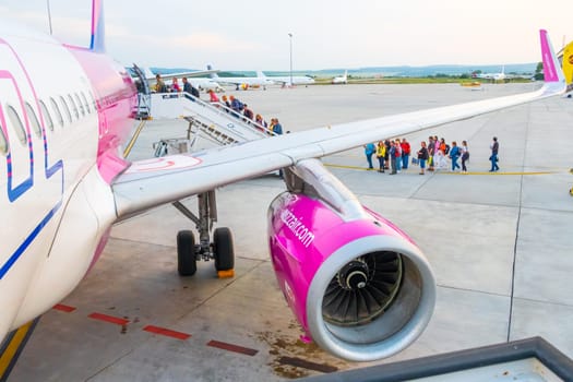 Wizzair airplane turbine and people boarding the plane, January 2024, Prague, Czech Republic