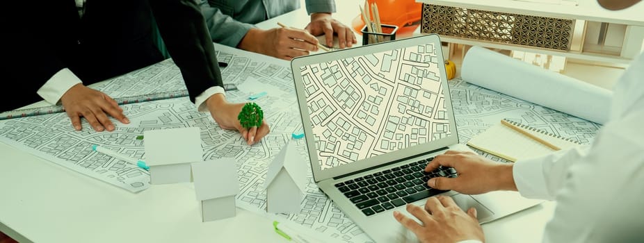 Worker, architect and engineer work on real estate construction project oratory planning with cartography and cadastral map of urban town area to guide to construction developer business plan of city