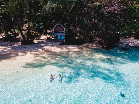 Koh Wai Island Trat Thailand near Koh Chang. wooden bamboo hut bungalow on the beach with a turqouse colored ocean. a young couple of men and woman on a tropical Island in Thailand