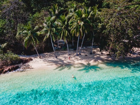 wooden bamboo hut bungalow on the beach with a turqouse colored ocean. a young couple of men and woman on a tropical Island in Thailand on vacation, Koh Wai Island Trat Thailand