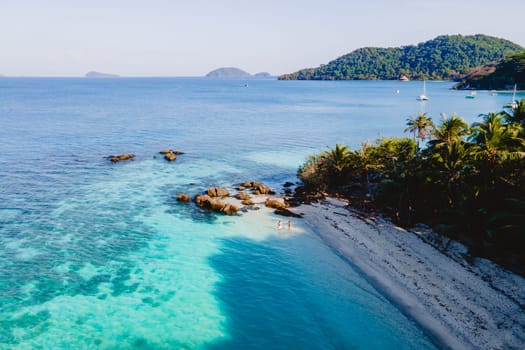 Drone aerial view at Koh Wai Island Trat Thailand. a young couple of men and women on a tropical beach during a luxury vacation in Thailand