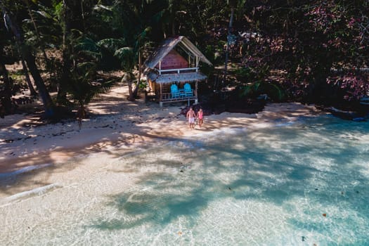 Koh Wai Island Trat Thailand is a tinny tropical Island near Koh Chang. wooden bamboo hut bungalow on the beach. a young couple of men and woman on a tropical Island in Thailand