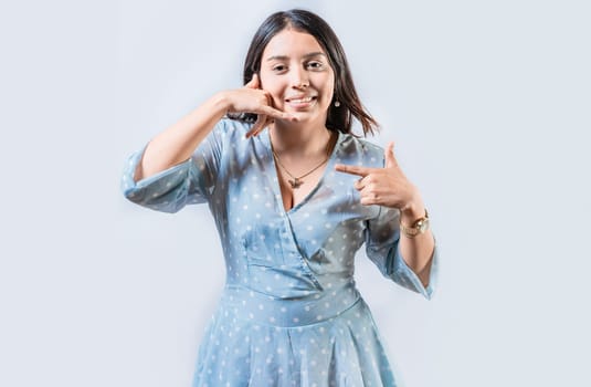 Young woman gesturing CALL ME in sign language isolated. Manual gestures of people with hearing problems