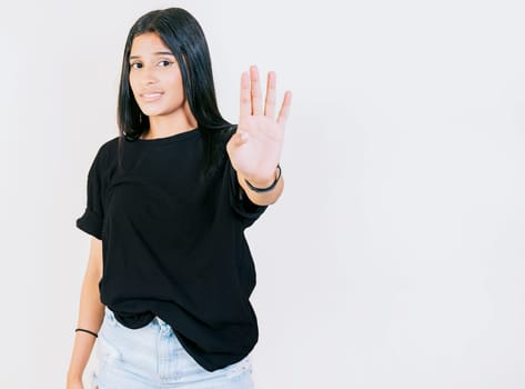 Teen girl gesturing stop with palm hand isolated. Young woman rejecting with the palm of hand isolated. People gesturing stop isolated