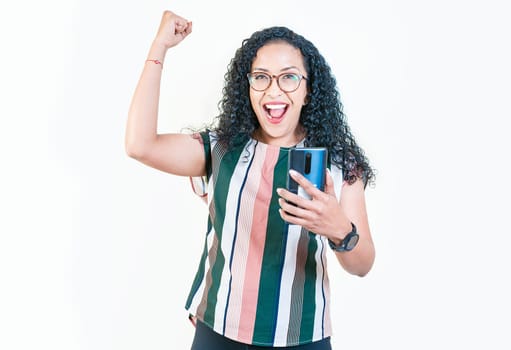 Winner young afro girl holding phone excited isolated. Happy afro woman holding smartphone and celebrating