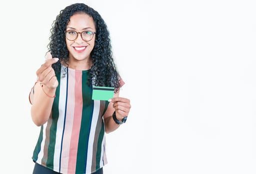 Happy afro girl in glasses holding credit card making money gesture with fingers, looking at camera isolated