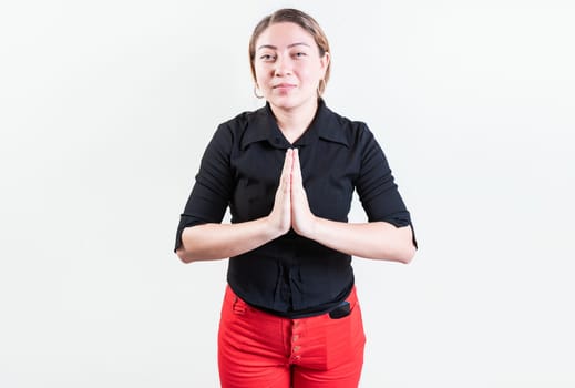 Attractive young woman asking for a favor isolated. Latin girl asking for help with her hands isolated