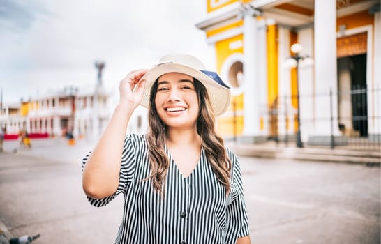 Portrait of beautiful tourist girl in the tourist square. Granada, Nicaragua. Portrait of happy traveler woman in a tourist square