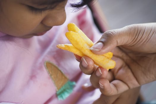 child eating french fries close up ,