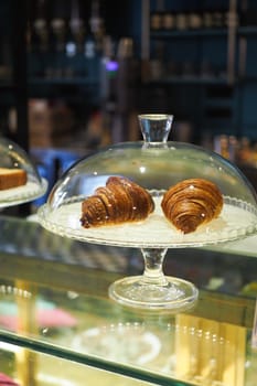 fresh baked croissant in a transparent jar at coffee shop
