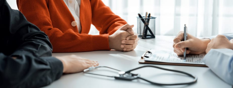 Couple attend fertility consultation with gynecologist at hospital as part family planning care for pregnancy. Loving husband and wife support each other through the doctor appointment. Panorama Rigid