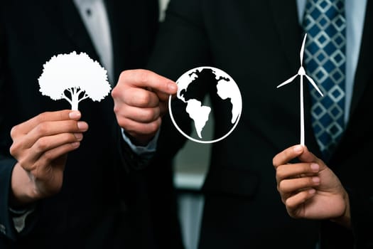 Group of business people holding alternative net zero energy icon for greener sustainable Earth with renewable energy technology to reduce CO2 emission. Quaint