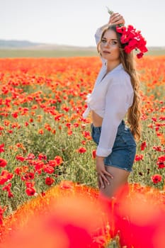 Woman poppies field. Side view of a happy woman with long hair in a poppy field and enjoying the beauty of nature in a warm summer day