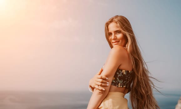 Woman travel sea. Happy tourist taking picture outdoors for memories. Woman traveler looks at the edge of the cliff on the sea bay of mountains, sharing travel adventure journey.