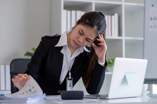 Business woman feeling tired from working in the office.