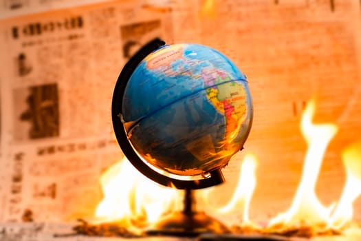 Model globe on fire. Planet Earth Burning. Global Warming and Climate Change Concept.