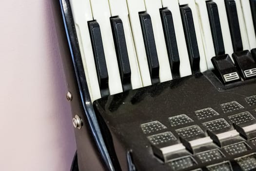 Keys of a black old accordion close up