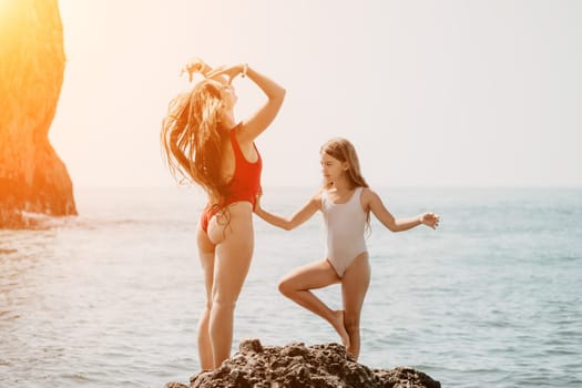 Silhouette mother and daughter doing yoga at beach. Woman on yoga mat in beach meditation, mental health training or mind wellness by ocean, sea