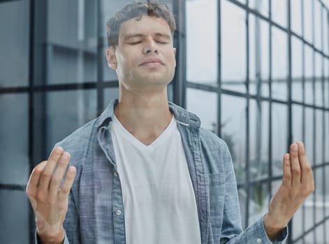 man resting in office relaxing, businessman meditating in lotus position