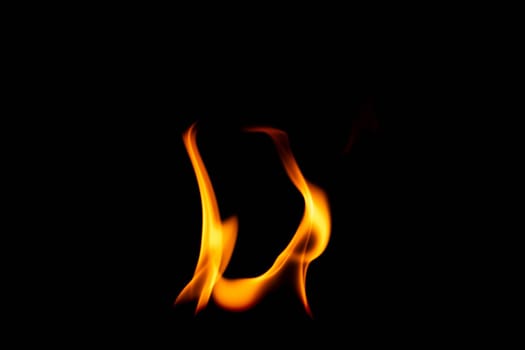 Hot flames on a black background. Beautiful flame of fire in the dark. Abstract of burning flames and smoke.