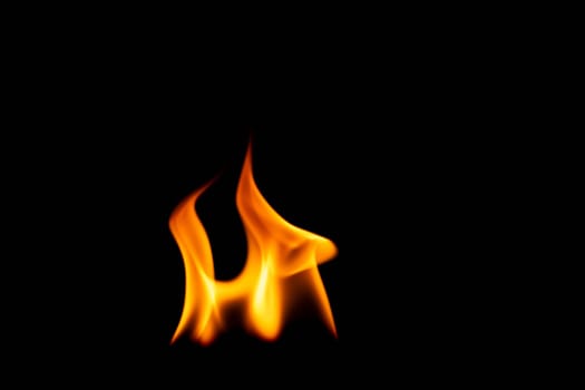 Hot flames on a black background. Beautiful flame of fire in the dark. Abstract of burning flames and smoke.