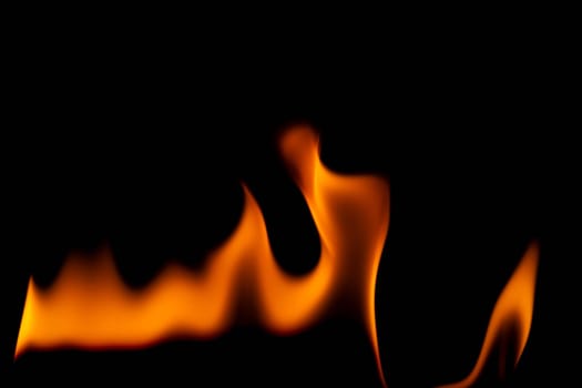 Hot flames on a black background. Beautiful flame of fire in the dark. Abstract of burning flames and smoke.