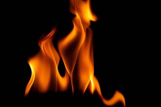 Hot flames on a black background. Beautiful flame of fire in the dark. Abstract of burning flames and smoke.