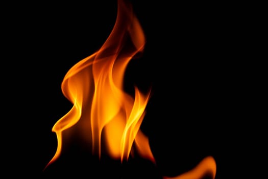 Hot flames on a black background. Beautiful flame of fire in the dark. Abstract of burning flames and smoke.