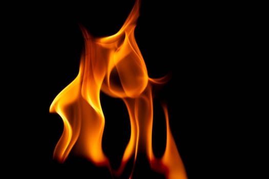 Hot flames on a black background. Beautiful flame of fire in the dark. Abstract of burning flames and smoke.