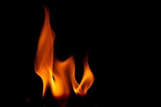 Hot flames on a black background. Beautiful flame of fire in the dark. Abstract of burning flames and smoke.