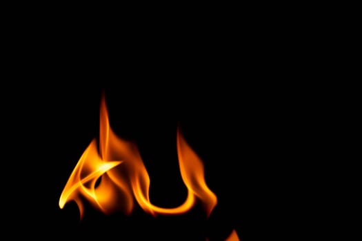 Hot flames on a black background. Beautiful flame of fire in the dark. Abstract of burning flames and smoke.