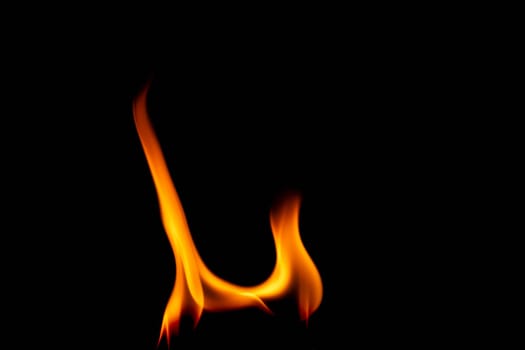 Hot flames on a black background. Beautiful flame of fire in the dark. Abstract of burning flames and smoke.