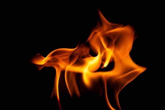 Hot flames on a black background. Beautiful flame of fire in the dark. Abstract of burning flames and smoke.