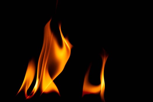 Hot flames on a black background. Beautiful flame of fire in the dark. Abstract of burning flames and smoke.