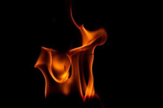 Hot flames on a black background. Beautiful flame of fire in the dark. Abstract of burning flames and smoke.