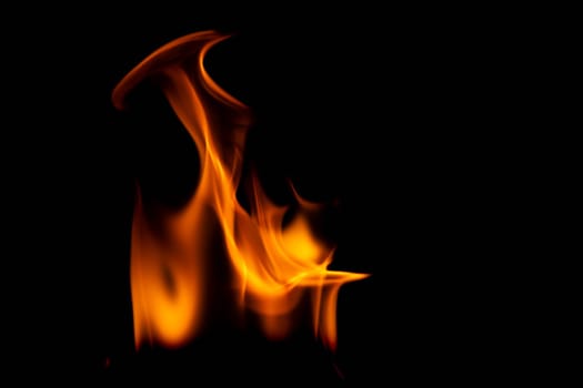 Hot flames on a black background. Beautiful flame of fire in the dark. Abstract of burning flames and smoke.