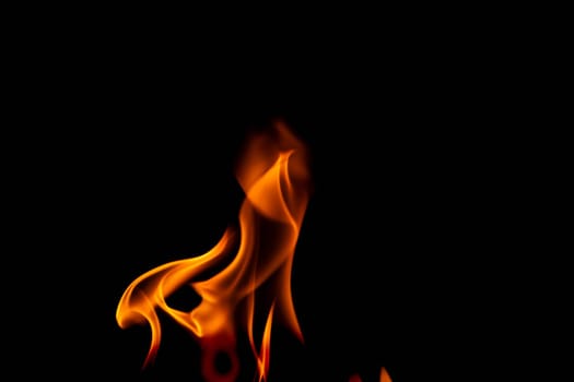 Hot flames on a black background. Beautiful flame of fire in the dark. Abstract of burning flames and smoke.