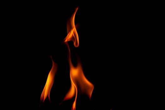 Hot flames on a black background. Beautiful flame of fire in the dark. Abstract of burning flames and smoke.