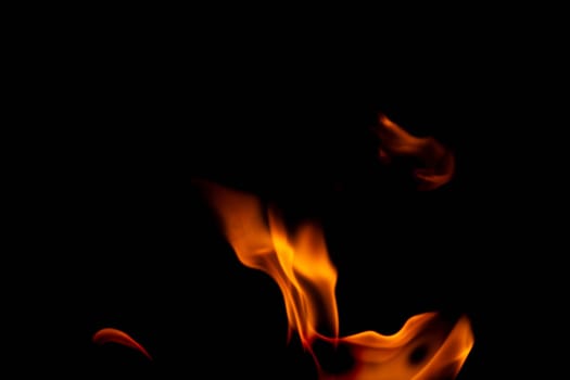 Hot flames on a black background. Beautiful flame of fire in the dark. Abstract of burning flames and smoke.