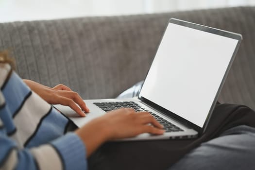 Close up of woman hands typing on laptop, online learning, working from home