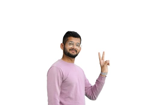 A man, on a white background, in close-up, shows a victory sign.