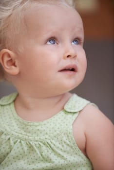 Baby, kid and girl play in home, adorable and cute child closeup alone in house. Young blonde toddler, innocent and childhood development for learning, education and thinking in kindergarten nursery.