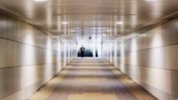 Exit the tunnel underpass and stairs in sunlight, blurred background