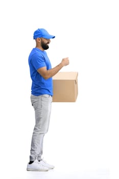 A male deliveryman, on a white background, in full height, with a box, shows a stop sign.