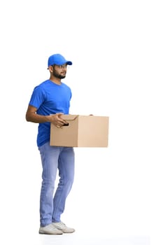 A male deliveryman, on a white background, full-length, with a box.