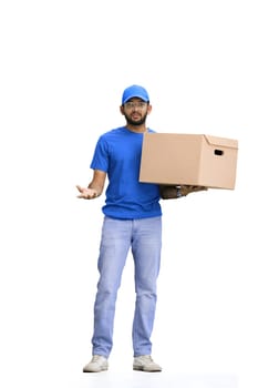 A male deliveryman, on a white background, in full height, with a box, throws up his hands.