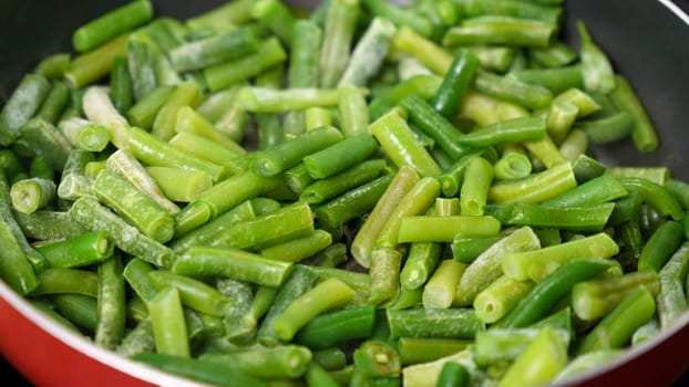 Green Beans Sizzling in Pan, Creating a Mouthwatering Dish. Selective focus