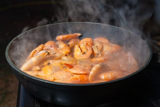 Succulent Shrimp Simmering in a Steamy Cast Iron Skillet Over an Open Flame