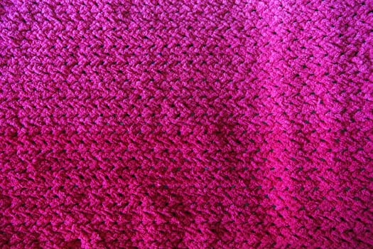 Close-Up of an Intricately Textured Pink Crocheted Blanket